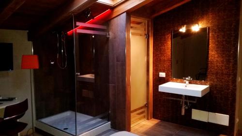 a bathroom with a glass shower and a sink at Etruria Relais and Wine in Rome