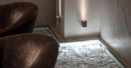 a room with a glass floor in a room with a chair at Hotel Sporting in Rimini