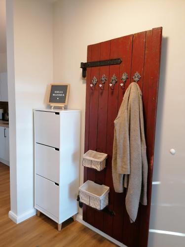 a sliding barn door with towels and a refrigerator at Strohböhn in Oldendorf