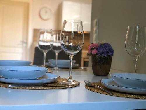 a table with plates and wine glasses on it at Strohböhn in Oldendorf