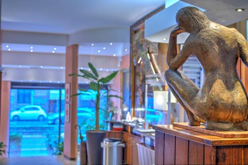 a statue of a woman sitting on a table in a store at Hotel Mec in Milan