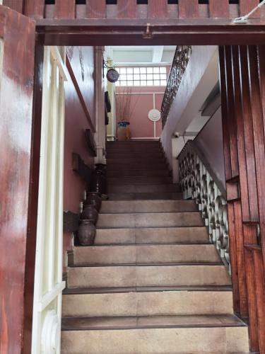 a staircase leading up to a room with pink walls at RedDoorz near Colgante Bridge Naga City in Naga