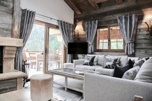 a living room with a couch and a table at Chalet Skyfall by Mrs Miggins in Grimentz