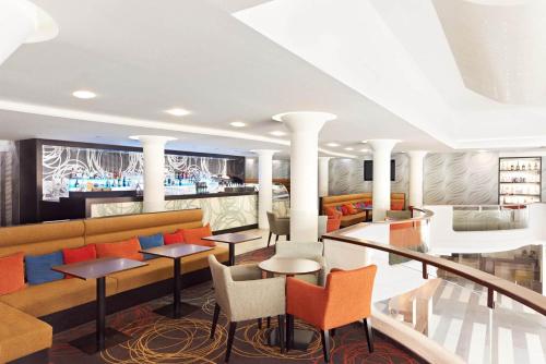 a lobby of a hotel with colorful chairs and tables at Hotel Europa Fit Hévíz in Hévíz