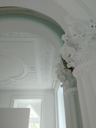 a room with a ceiling with a pillar and a window at Palácio do Visconde - The Coffee Experience in Lisbon