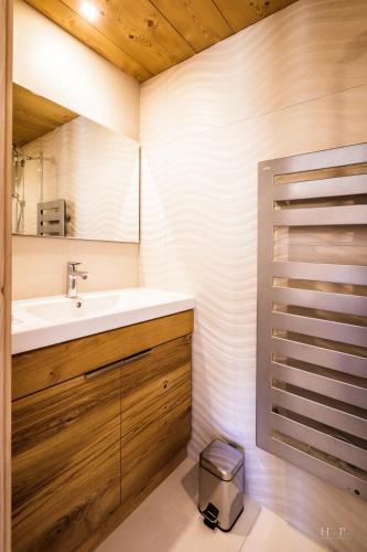 a bathroom with a sink and a mirror at Ski in ski out Le Moulin charming duplex just 50 m from Princesse gondola Megève in Demi-Quartier