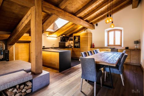 a kitchen and dining room with a table and chairs at Ski in ski out Le Moulin charming duplex just 50 m from Princesse gondola Megève in Demi-Quartier