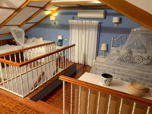 a room with a staircase with a bed and a cup on a table at Antigua Estación de Campanillas in Málaga