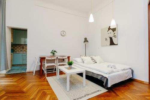 a living room with a bed and a table at ShortStayPoland Klonowa (B29) in Warsaw