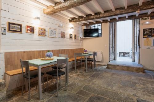 a dining room with two tables and chairs at Albergue The Last Stamp in Santiago de Compostela