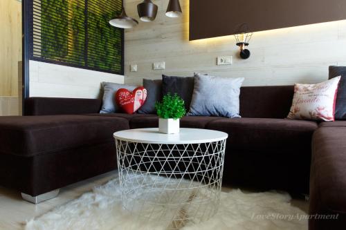 a living room with a couch and a table at Luxury apartments «Love Story» in Ivano-Frankivsʼk