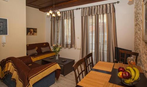 a living room with a table and a dining room at Argyro House I in Rethymno Town