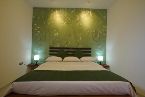 a bedroom with a large bed with two lamps at Monaara Leisure - Anuradhapura in Anuradhapura