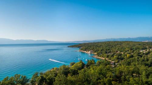 a view of a lake with a boat in the water at Veya Maradiso Hotel by Aminess in Njivice