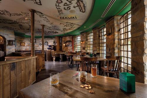 a restaurant with wooden tables and a green ceiling at Seminaris SeeHotel Potsdam in Potsdam