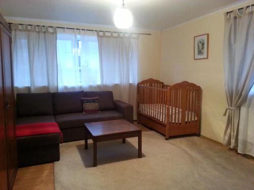 a living room with a couch and a crib at Tanuma Apartment in Tallinn
