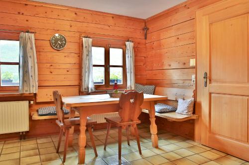 a wooden dining room with a table and chairs at Hafnerhof in Einöden
