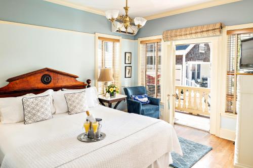 a bedroom with a bed and a chair at Brass Key Guesthouse Adults Only in Provincetown