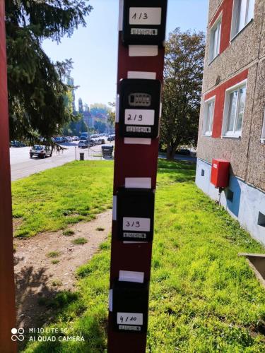 a pole with clocks on it next to a building at Monteurwohnung-Workere's apartment-Gera in Gera