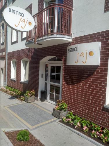 a brick building with a sign that reads bistro at Tom&Tom in Białogard