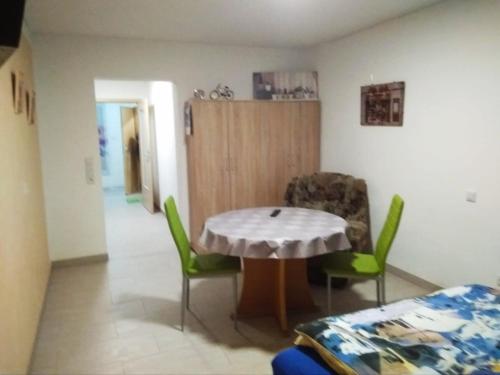 a room with a table and chairs in a room at Ferienwohnung Sowade in Nebra