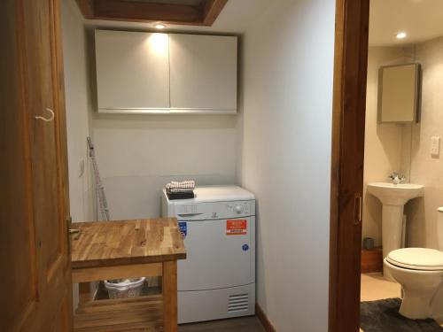 a small bathroom with a white refrigerator and a toilet at Yairbrig Holiday in Galashiels