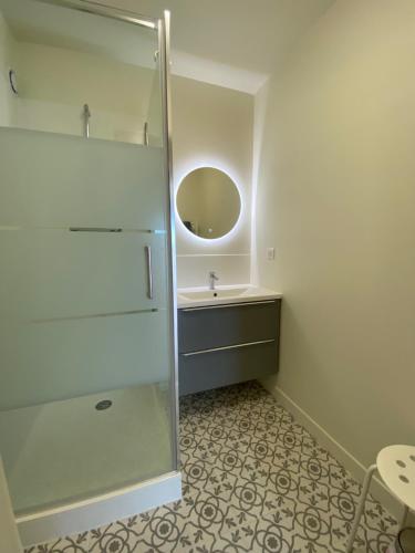 a bathroom with a sink and a mirror at Hyper Centre - 2 PIÈCES tout confort - Terrasse - ascenseur - in Cabourg