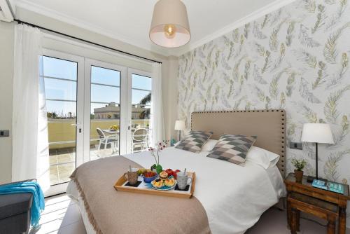 a bedroom with a bed with a tray of fruit on it at Penthouse Daniela in Puerto Mogan IX in Puerto de Mogán