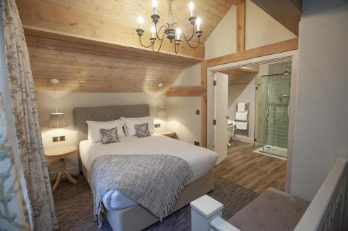 a bedroom with a bed and a chandelier at The Lion at Malpas in Malpas