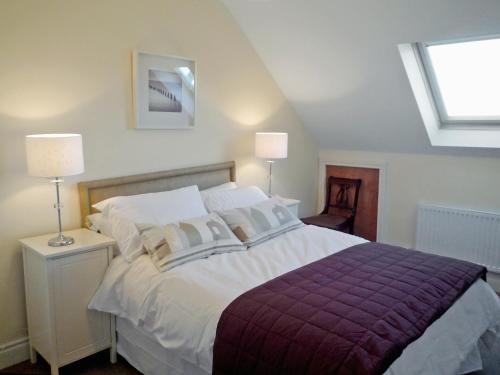 1 dormitorio con 1 cama grande y 2 lámparas en Cnocan Na Cuaig Carraroe by Trident Holiday Homes, en Carraroe