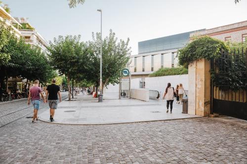 a group of people walking down a street at Athens Studios in Athens