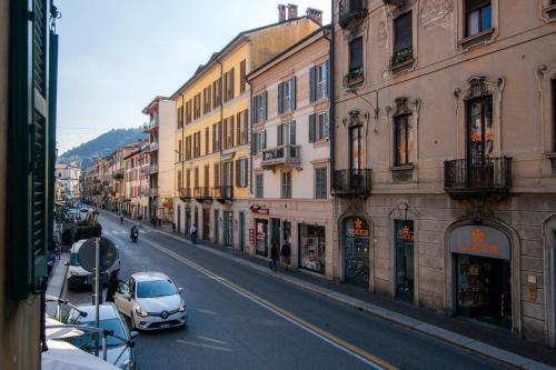 a car parked on a city street with buildings at Downtown Como-Porta Torre Flat in Como