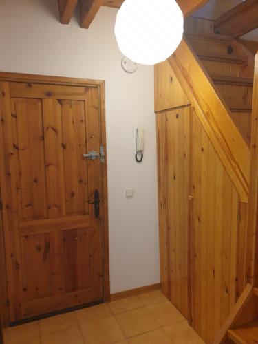 a room with a wooden door and a lamp at Dúplex Pla de L'Ermita (Boí Taüll) in Pla de l'Ermita