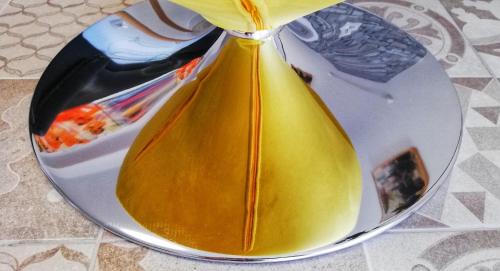 a yellow vase on a plate on a table at Casa Princesa Huelin in Málaga
