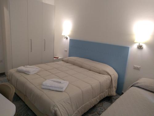 En eller flere senge i et værelse på Locanda B&B Dandana