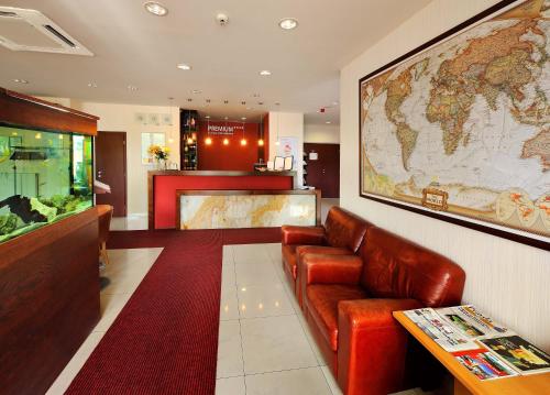
a living room filled with furniture and a red wall at PREMIUM Business Hotel Bratislava in Bratislava
