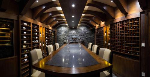 a long wooden table in a wine cellar with chairs at The Royal Yacht in Saint Helier Jersey