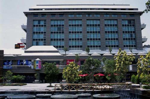 a large building with a fountain in front of it at Svelte Delhi, a member of Radisson Individuals in New Delhi