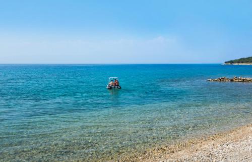 a group of people in a boat in the water at Magal Maradiso Hotel by Aminess in Njivice