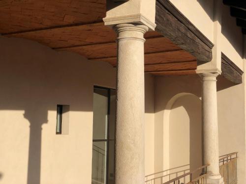 a building with two columns and a wooden ceiling at Locanda San Silvestro - Meride in Mendrisio