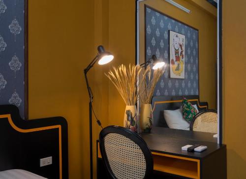 a bedroom with a desk with a lamp and a mirror at VietHouse Homestay Ha Long in Ha Long