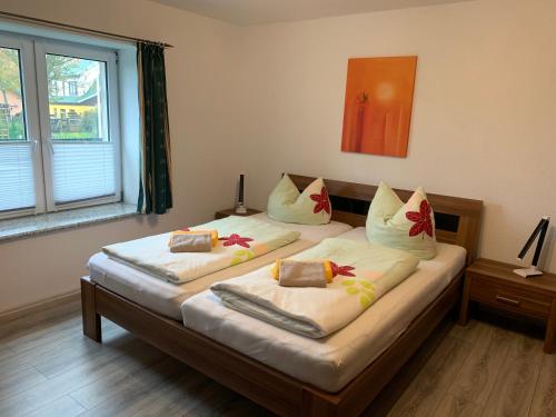 a bedroom with two beds with pillows on them at Ferienwohnungen Zur alten Schule in Altenkirchen