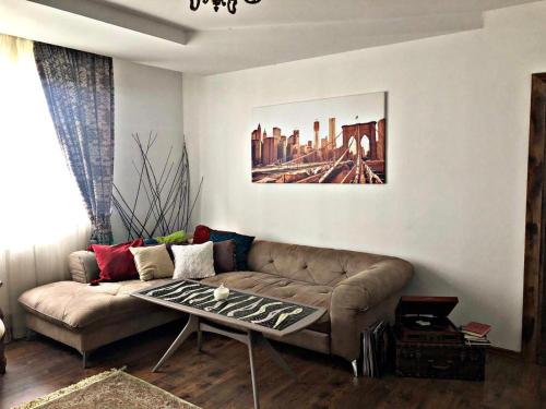 a living room with a couch and a table at Vintage touch apartment in Cluj-Napoca