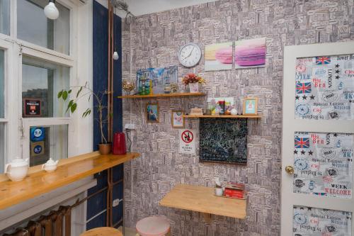 a room with a wall with a clock on it at Loft Hostel Minsk in Minsk