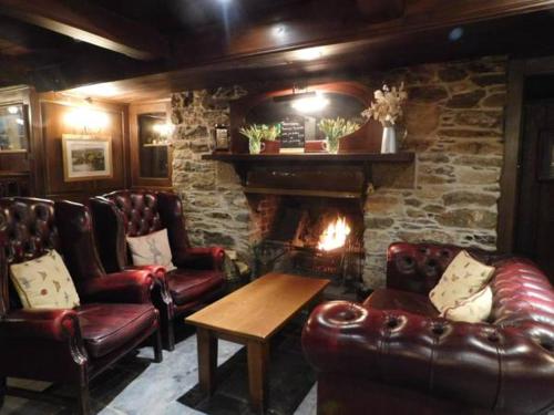 a living room filled with furniture and a fire place at Edgcumbe Arms in Torpoint