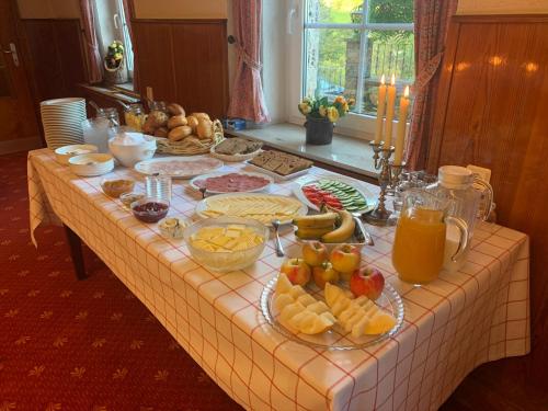 a table with a buffet of food and drinks at The Conscious Farmer Bed and Breakfast Sauerland in Willingen