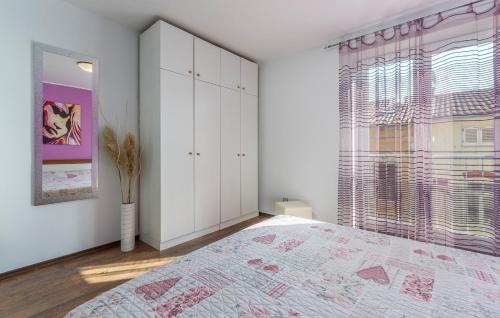 a bedroom with a large bed and a window at Apartment Marino in Poreč