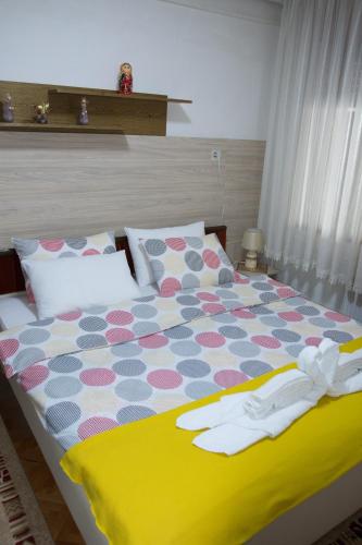 a bedroom with a bed with a colorful comforter at Apartment Elmari in Prilep