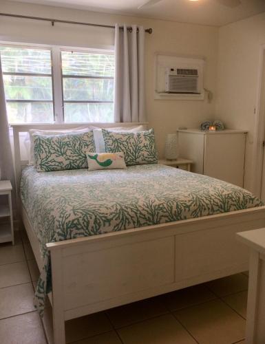 a bed in a room with a window at Gorgeous Beachy Chic Condo in Key Biscayne in Miami