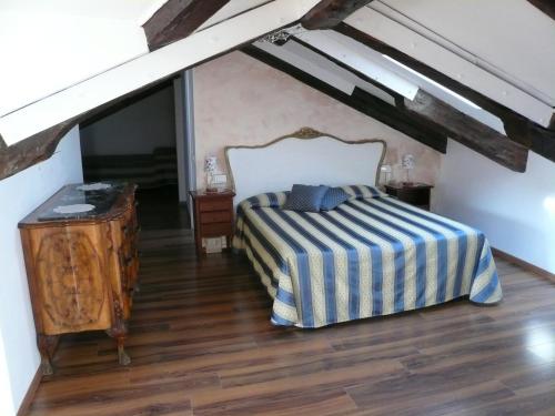 a bedroom with a bed and a wooden floor at Corte Canal Venice in Venice